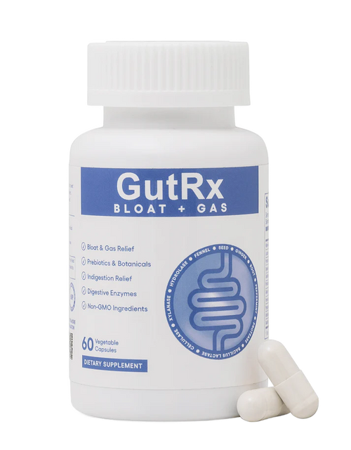 A white plastic bottle of GutRx Bloat + Gas dietary supplement capsules with two capsules resting in front, on a clean white background.