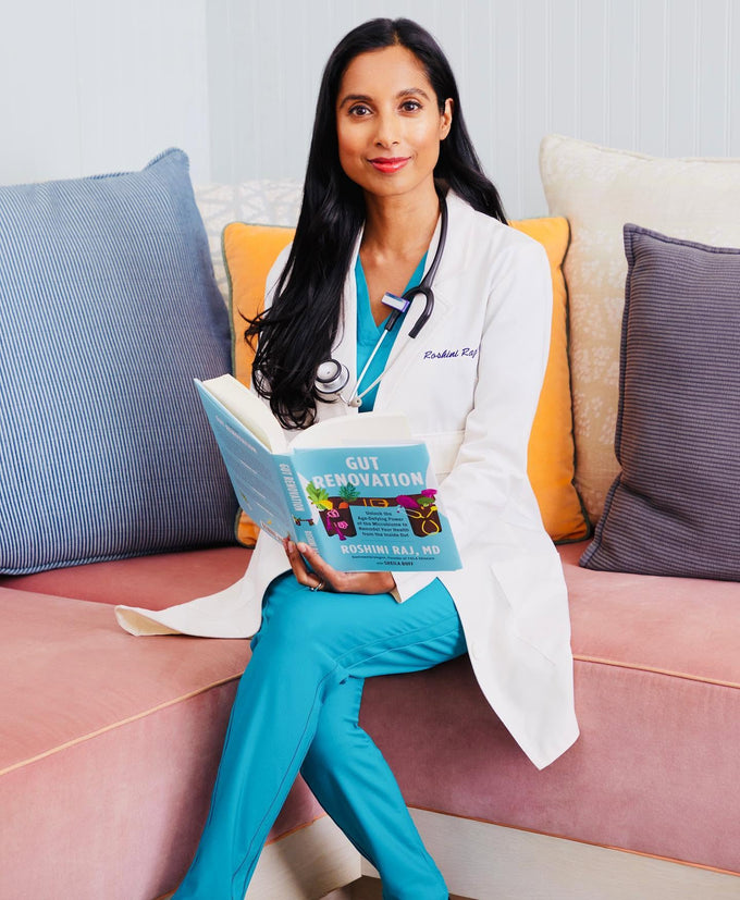 Dr. Roshini Raj, MD, holding her microbiome book Gut Renovation