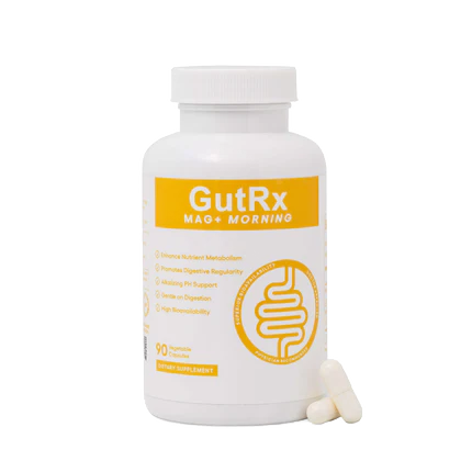 A white bottle of GutRx Mag + Morning dietary supplement with a yellow label, shown on a white background with two white capsules in front.
